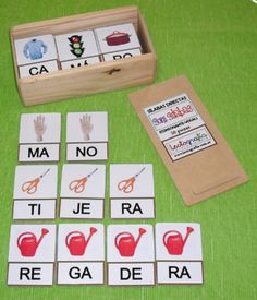 a wooden box filled with matching cards next to a pair of scissors and other items