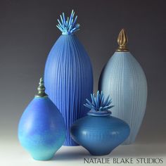 three blue vases are sitting next to each other on a white surface with the words natalie bake studios written below them