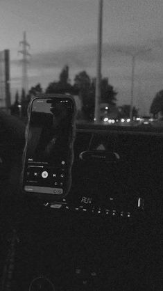 a cell phone sitting on the dashboard of a car