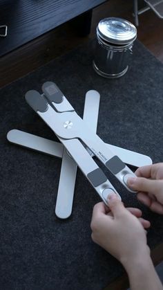 a person cutting up scissors on top of a table