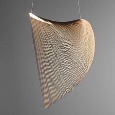 a wooden light fixture hanging from a wire on a gray background with the words,'wood