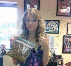 a woman holding up a bag of cookies