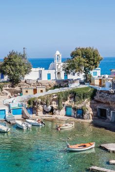 an island with several small boats in the water and some buildings on top of it