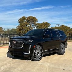 a black suv is parked in the parking lot