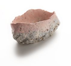 a stone bowl sitting on top of a white table