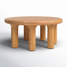 a round wooden table with four legs and a circular top, on a white background