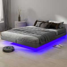 a bed that has been lit up with blue lights on the bottom and underneath it