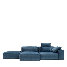 a blue sectional sofa with pillows on the top and bottom, in front of a white background