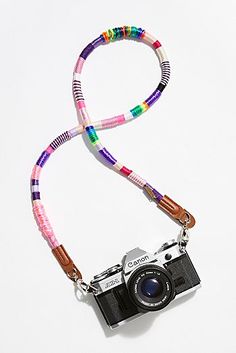 a camera is attached to a lanyard with colorful beads