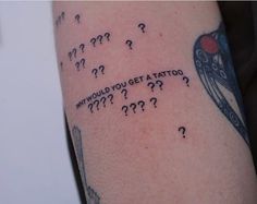 a tattoo with question marks on it