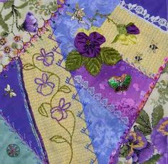 a patchwork quilt with flowers and butterflies on it