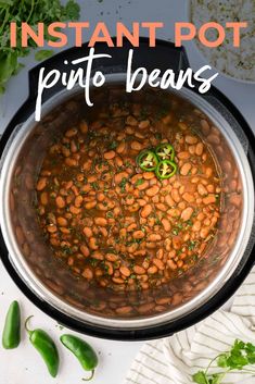 instant pot pinto beans in a pan with green peppers and cilantro on the side