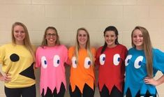 four girls in costumes standing next to each other