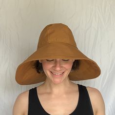 "Say hello to the sun hat of your dreams!  The oversized brim - made from a beautifully neutral Carhartt Brown canvas - protects your face and neck from the sun.  The inner crown is lined with the lightest, softest SWEAT WICKING technical fabric.  This hat is fully foldable, packable, mushable--take it anywhere! Specifications:  100% Cotton Canvas Outer  Polyester Moisture Wicking Liner Nylon Cordura Interfacing Measurements: Size Small head size 22\" (56 cm) Size Medium head size 23\" (58 cm) Size Large  head size 24\" (61 cm)" Oversized Sun Hat, Waterproof Hat, Rain Accessories, Packable Hat, Small Head, Rain Hat, Wearing Glasses, Brown Canvas, Beach Hat