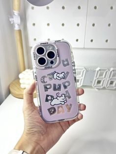 a person holding up a phone case with the words hello kitty on it