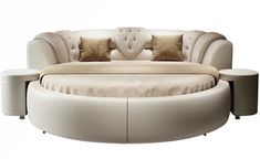 a round couch with pillows on top of it