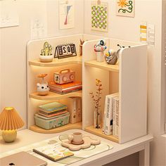 a room with a desk, bookshelf and other items on it's shelves