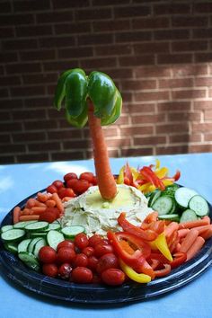 a plate filled with vegetables and carrots on top of a blue cloth covered table