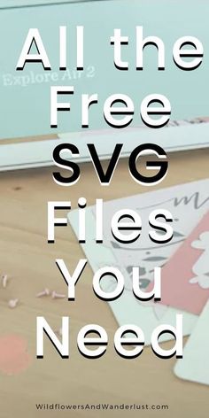 a laptop computer sitting on top of a wooden table next to paper and scissors with the words, all the free svg files you need