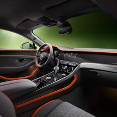 the interior of a sports car with orange trim