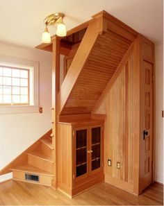 a wooden staircase leading up to a window