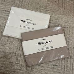two packages of pillowcases sitting on top of a carpeted floor next to each other