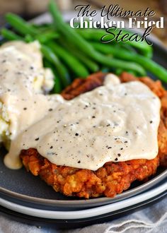 the ultimate chicken fried steak is served with gravy and green beans