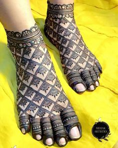 the feet are decorated with henna designs