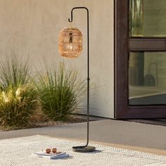 a pair of shoes is sitting on a plate in front of a building with a lamp