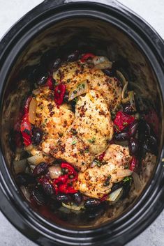 chicken, olives and peppers in an instant pot with the lid open to show it's contents