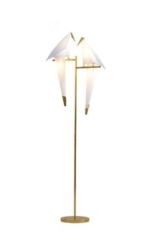 a floor lamp with two birds on it