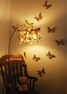 a teddy bear sitting in a chair next to a lamp and butterflies on the wall