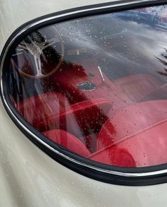 the interior of a car with rain drops on it