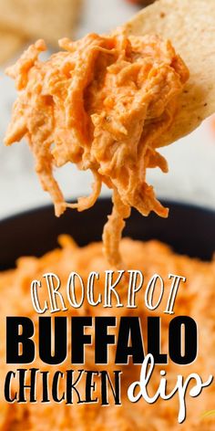 a spoon full of chicken dip being held by a tortilla chip with the words crockpot buffalo dip on it