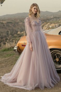 Arrive to any event looking like you stepped right out of a dream in the Fairy Tale Lilac Long Sleeve Tulle Maxi Dress! Elegant tulle shapes this stunning dress featuring a sweetheart neckline, sheer long puff sleeves and textured flowers along the shoulder line and neckline. Bustier bodice with hidden boning and padded cups tops a high fitted waist followed by a cascading maxi skirt. Open back with lace tie up for perfect fit. Handmade-To-Order Tulle & Polyester. Lined. Runs true to size. Hand Elegant Ball Dresses, Gaun Tulle, Tulle Maxi Dress, Applique Wedding, Sweetheart Prom Dress, Applique Wedding Dress, Evening Dresses Cocktail, Perfect Prom Dress, Cutout Dress