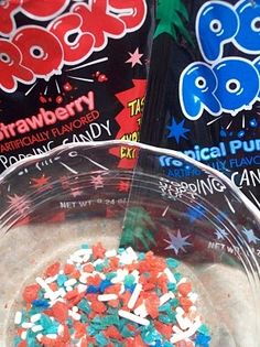 two bags of candy are sitting in a bowl with sprinkles on it