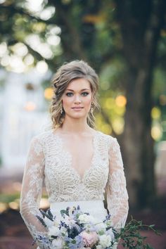 a woman in a wedding dress holding a bouquet