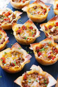 mini quiches with meat and cheese in them on a blue platter