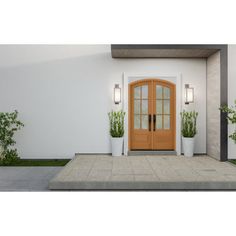 the front entrance to a white house with potted plants on either side and an orange door