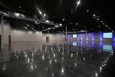 an empty room with blue lights on the ceiling