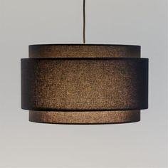 a brown and black lamp hanging from a ceiling