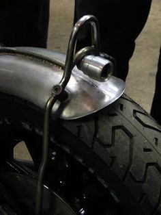 a close up of a motorcycle tire and handlebars