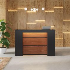 an office with wood paneling and black desk in front of a wooden wall that has lights on it