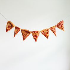 some slices of pizza are hanging on a string