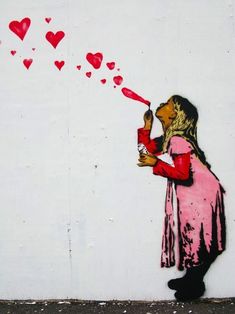 a painting of a girl blowing hearts on the wall