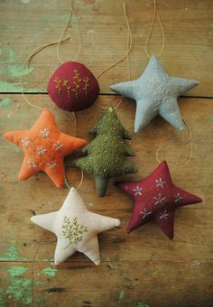 five star ornaments hanging from string on wooden surface