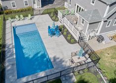 an aerial view of a backyard with a swimming pool