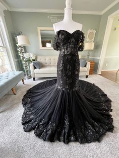 Our Cassie Wedding Dress is another version with our signature see through bodice mermaid wedding dress and it includes an addition of lace applique all over the train unlike the other version. This gorgeous Custom Black Mermaid  Wedding Dress with a sweetheart neckline is a total stunner! It includes off shoulder  sleeves, a structured  see through bodice with bonings, layers of tulle on the train and beautifully dispersed lace all over. It also has a lace up back which gives it a very romantic Black Wedding Dress Elegant Mermaid, Gothic Mermaid Wedding Dress, Black Wedding Dress Gothic Lace Gowns, Wedding Dress With Black Accents, Wedding Dress Black Lace, Black Mermaid Wedding Dress, Gothic Wedding Dress Black, Wedding Dress Gothic, Cassie Wedding