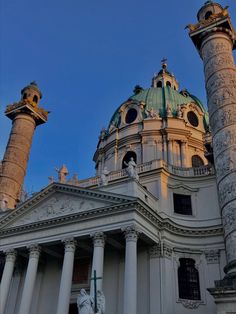 an ornate building with columns and statues on top