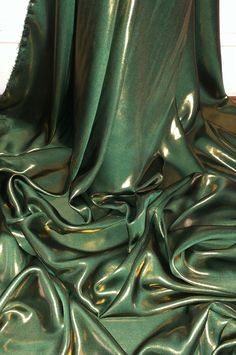 the green fabric is very shiny and smooth